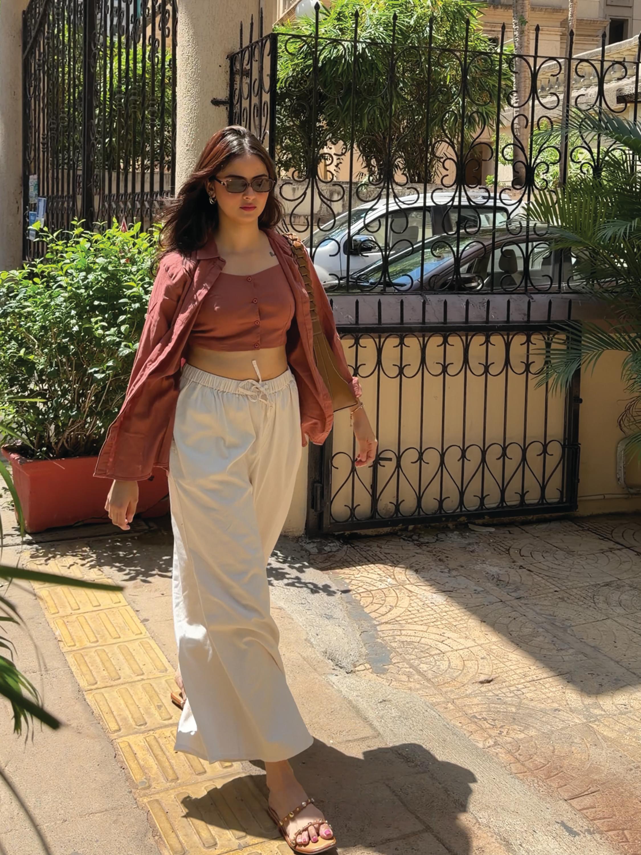 Person wearing white wide-leg pants by Rerasa