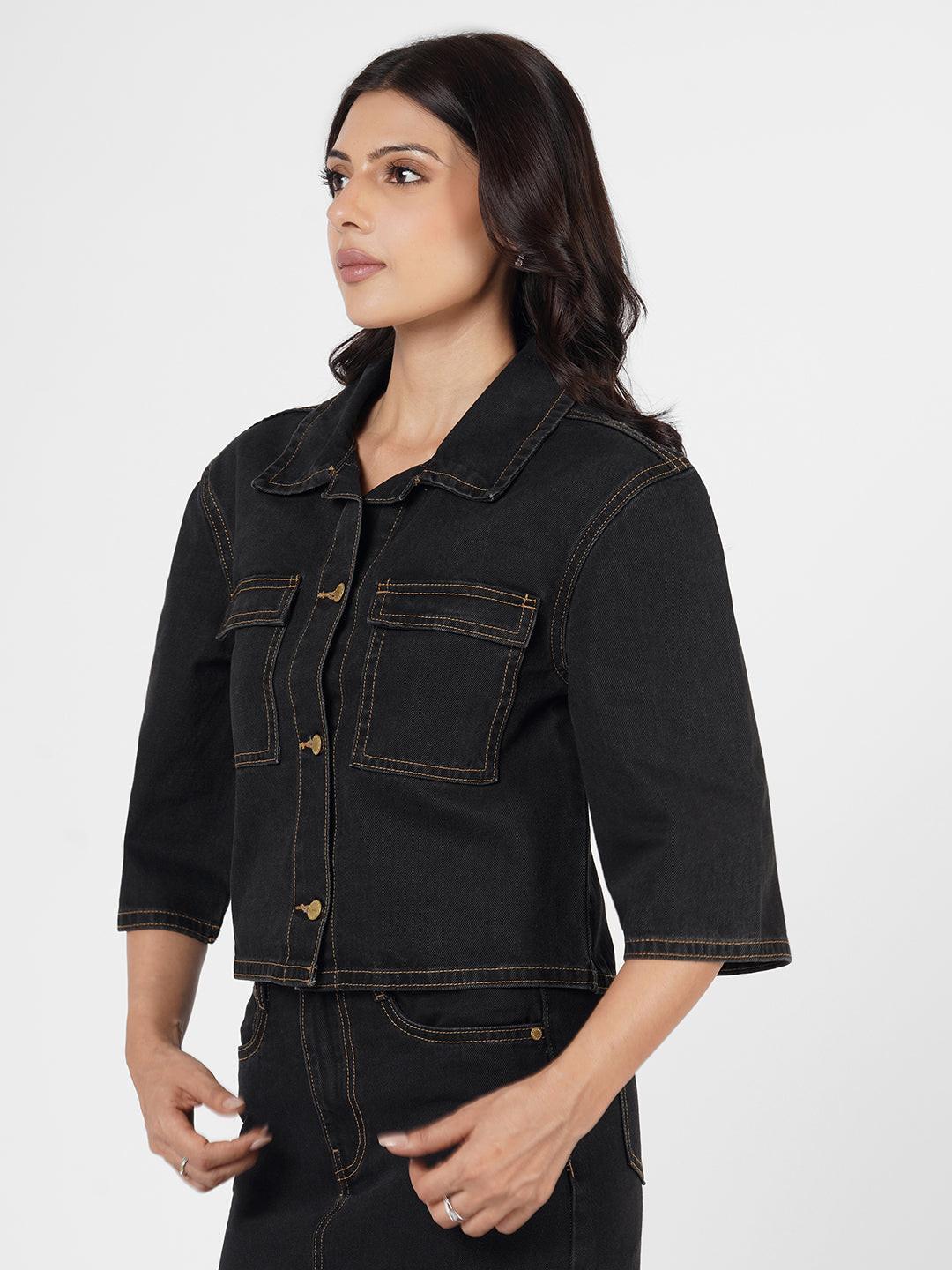 Woman wearing a dark denim Shacket by Rerasa