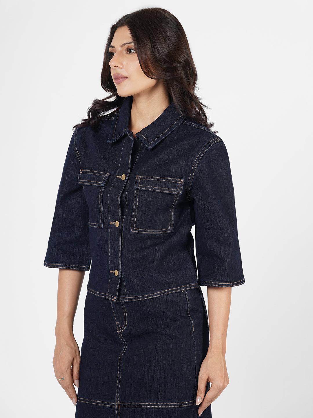 Woman wearing a dark denim Shacket by Rerasa