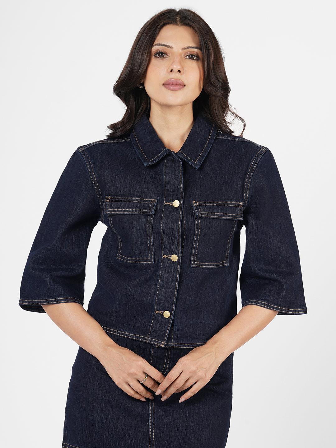 Woman wearing a dark denim Shacket by Rerasa