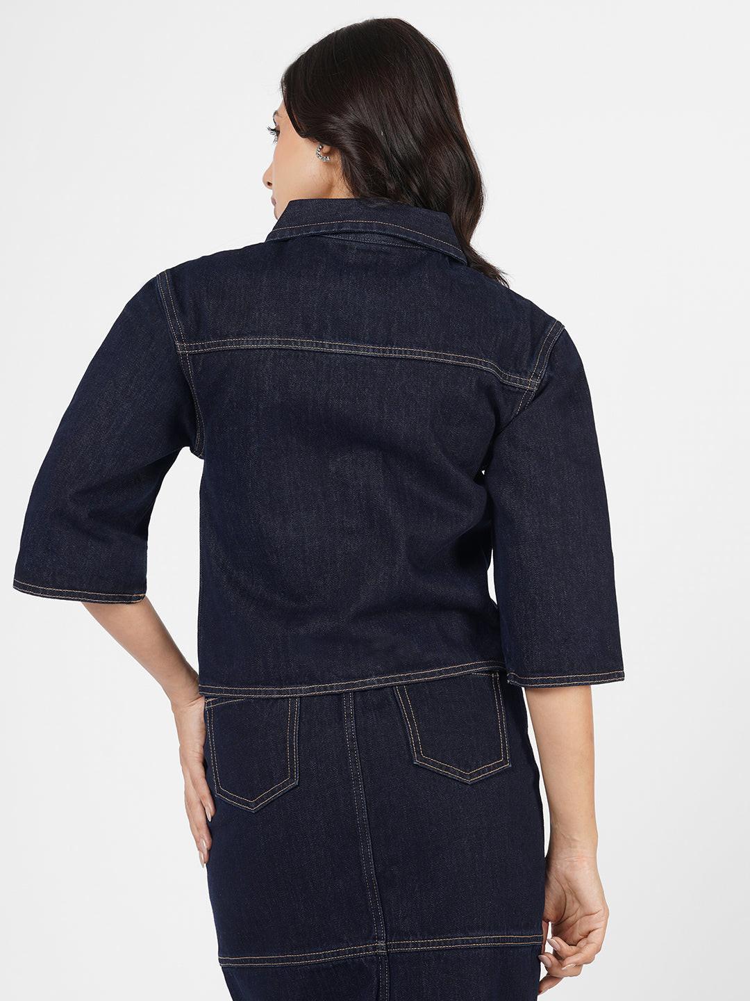 Woman wearing a dark denim Shacket by Rerasa