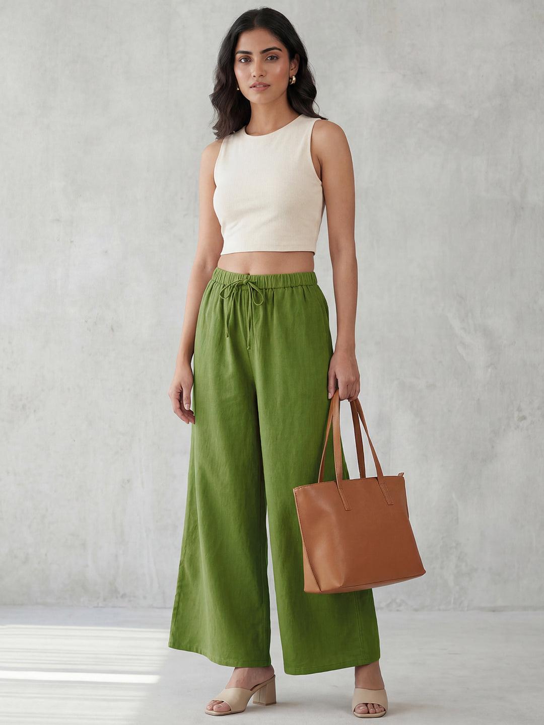 Person wearing green wide-leg pants by Rerasa