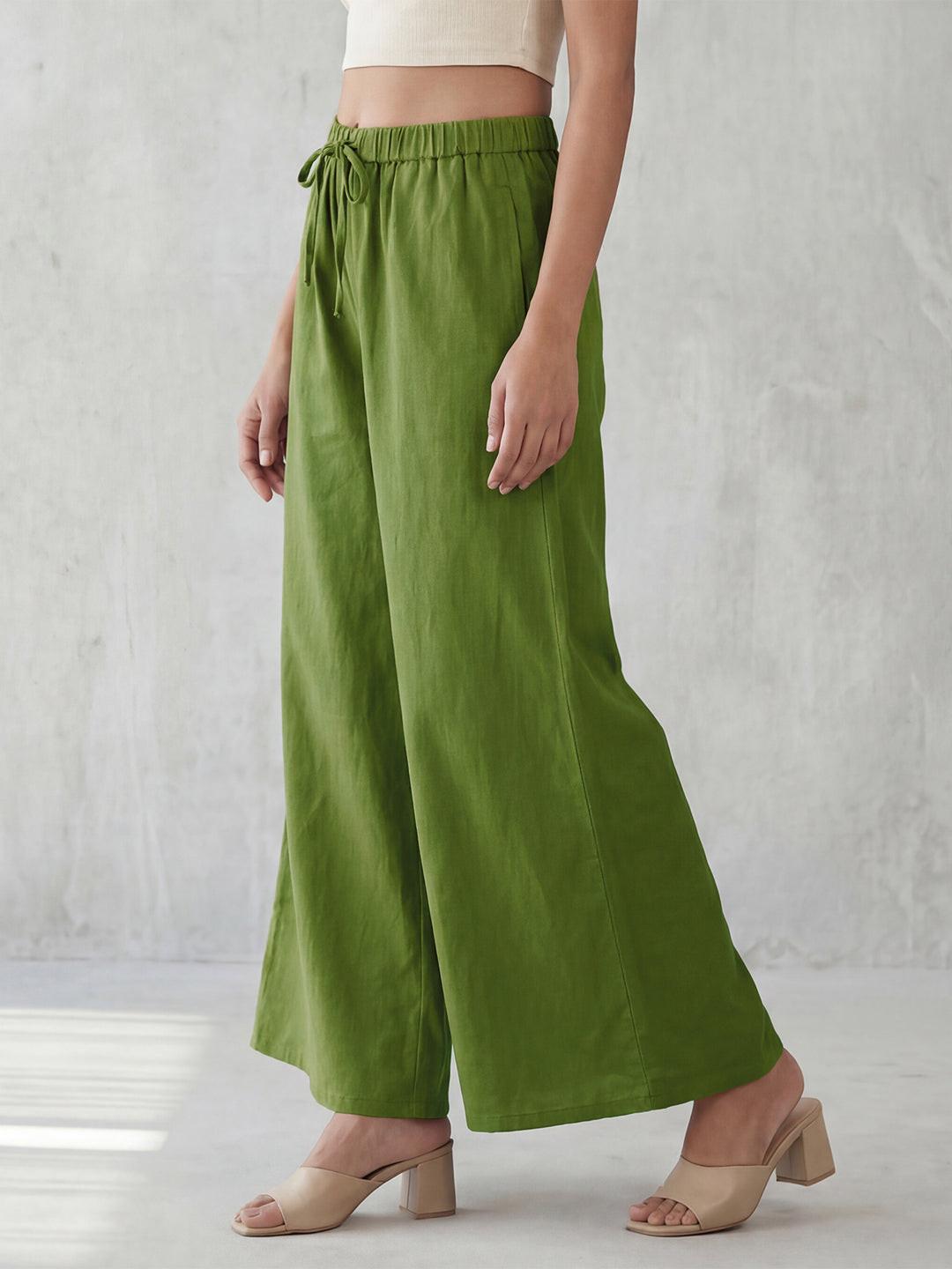 Person wearing green wide-leg pants by Rerasa