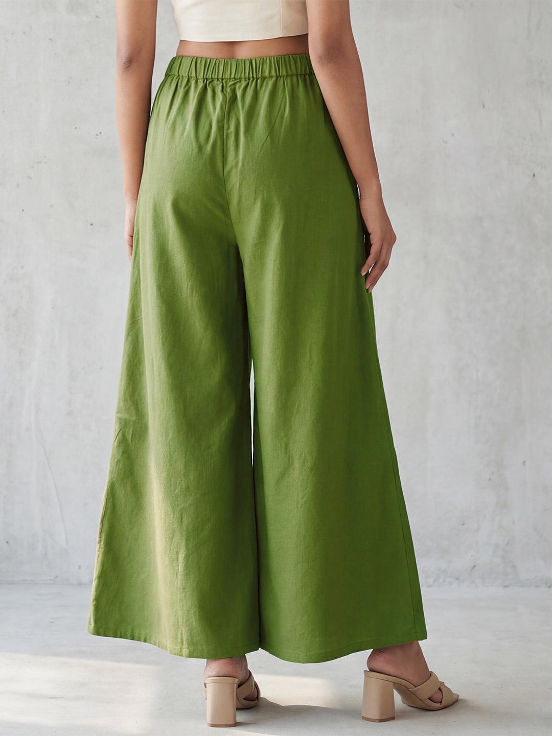Person wearing green wide-leg pants by Rerasa