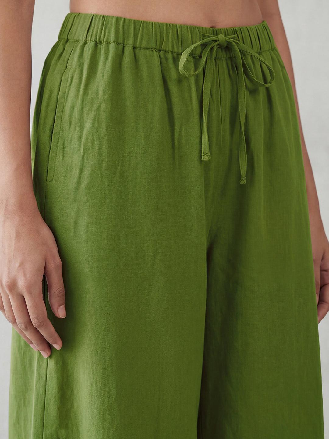 Person wearing green wide-leg pants by Rerasa