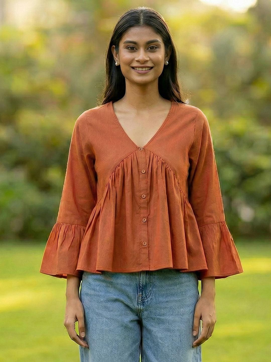 Woman wearing a Orange blouse with ruffled sleeves by Rerasa