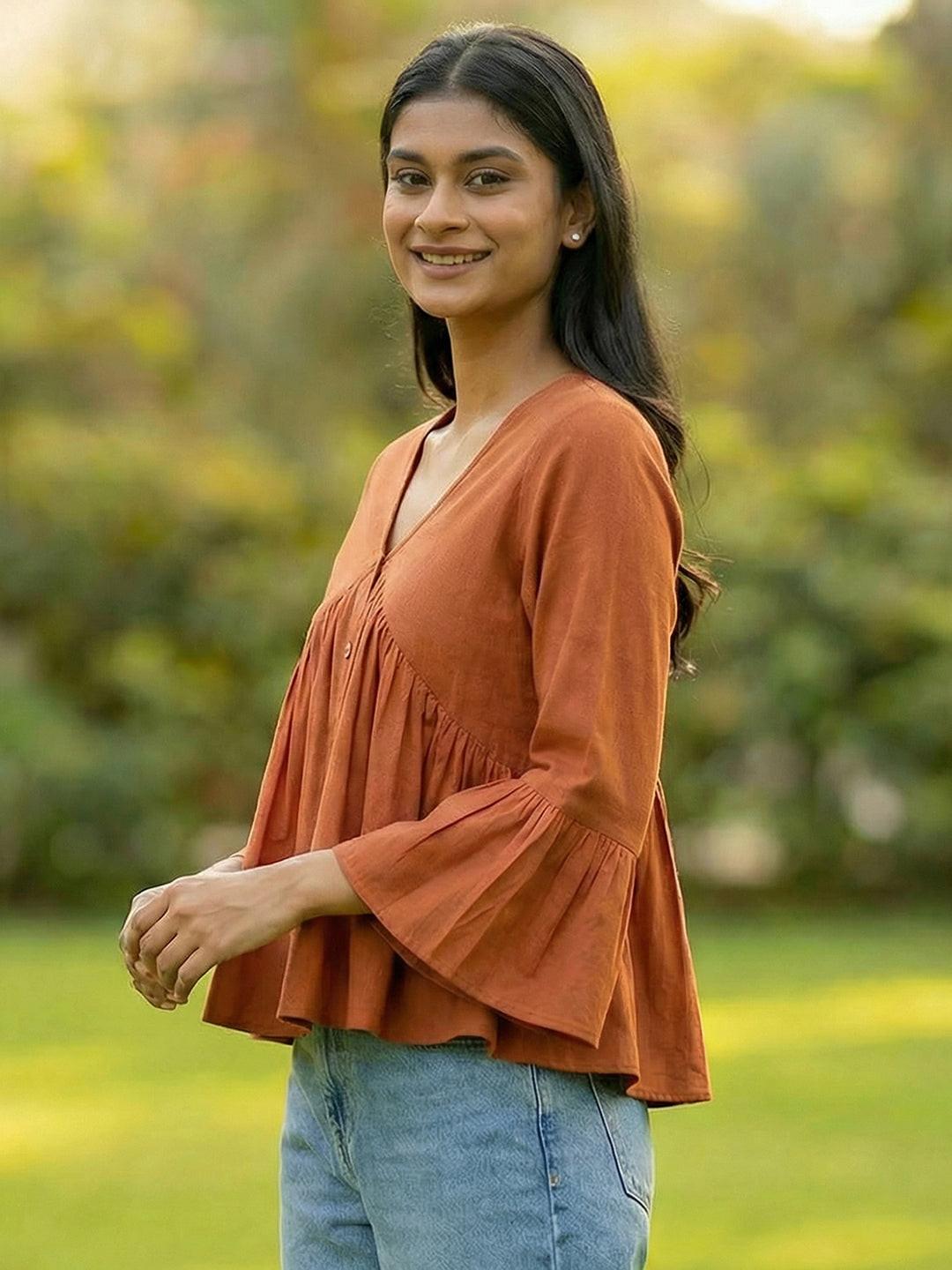 Woman wearing a Orange blouse with ruffled sleeves by Rerasa