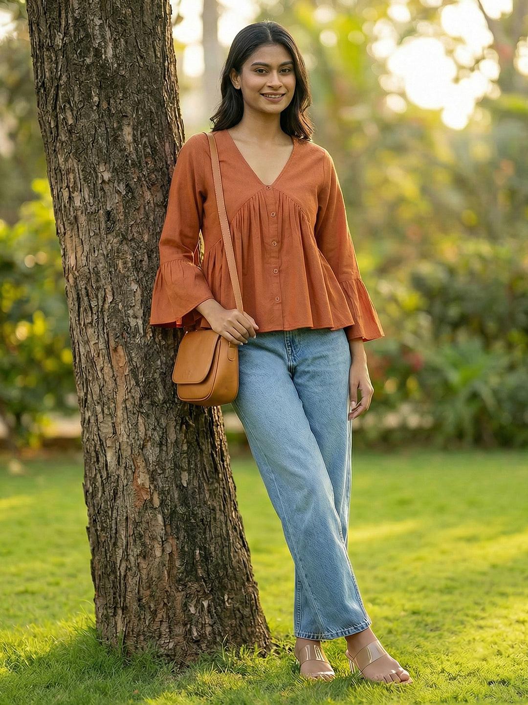 Woman wearing a Orange blouse with ruffled sleeves by Rerasa