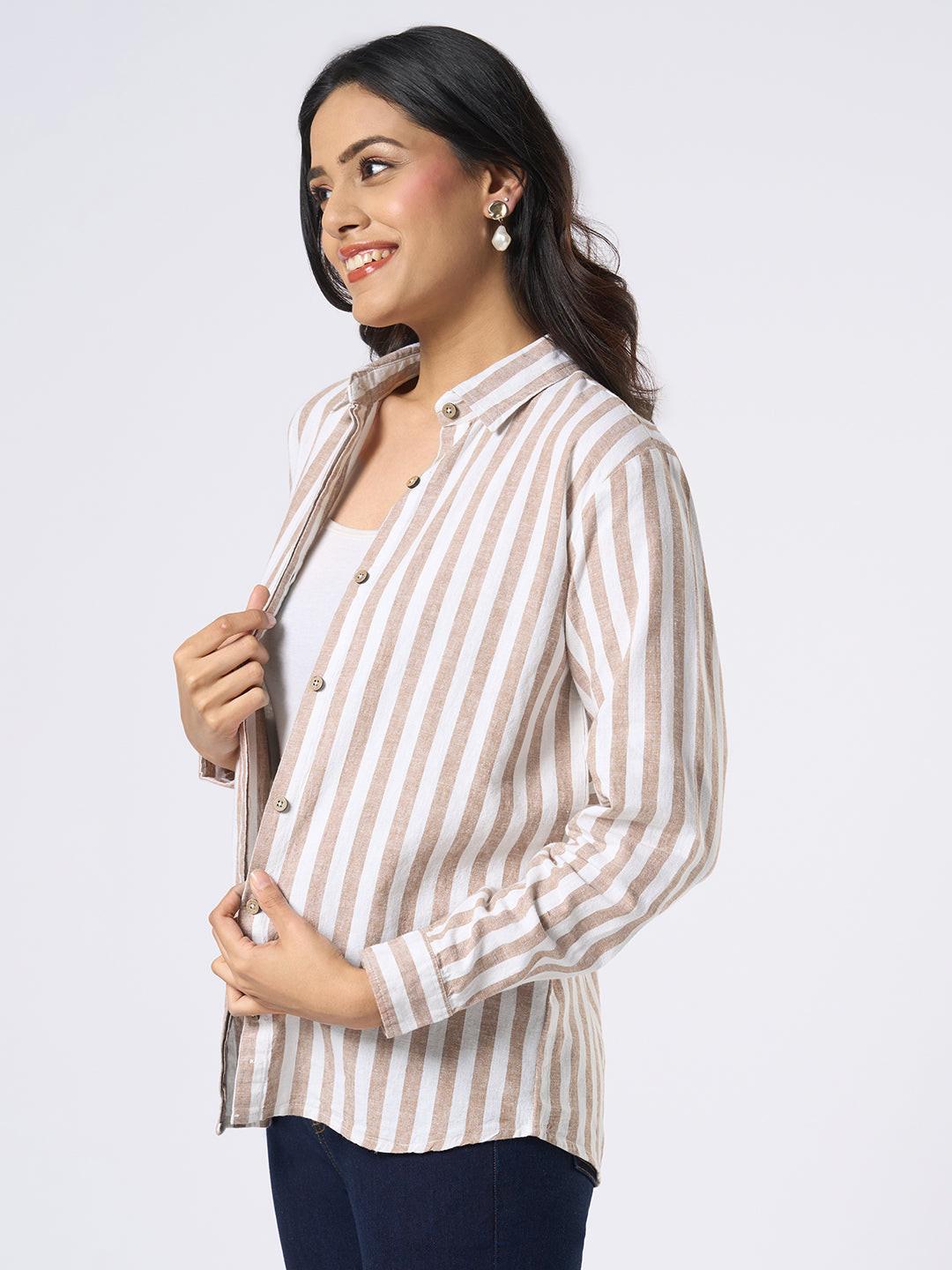 Woman wearing a Rerasa beige and white striped shirt against a plain background