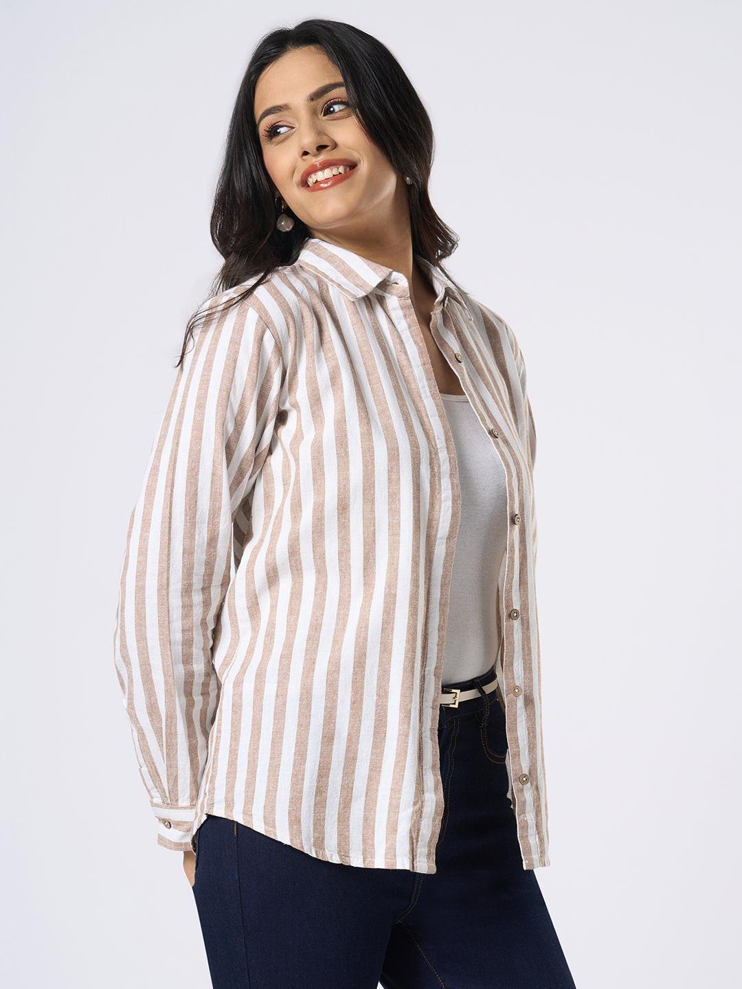 Woman wearing a striped shirt and dark pants on a white background