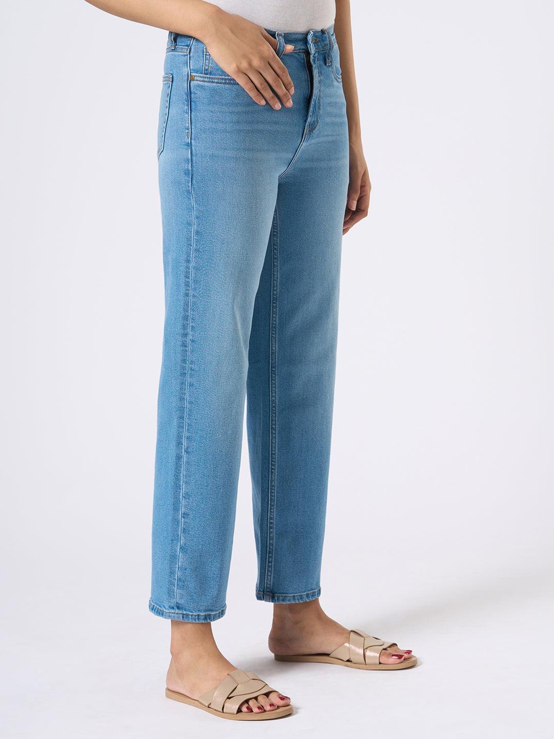 Person wearing Rerasa blue jeans on a white background