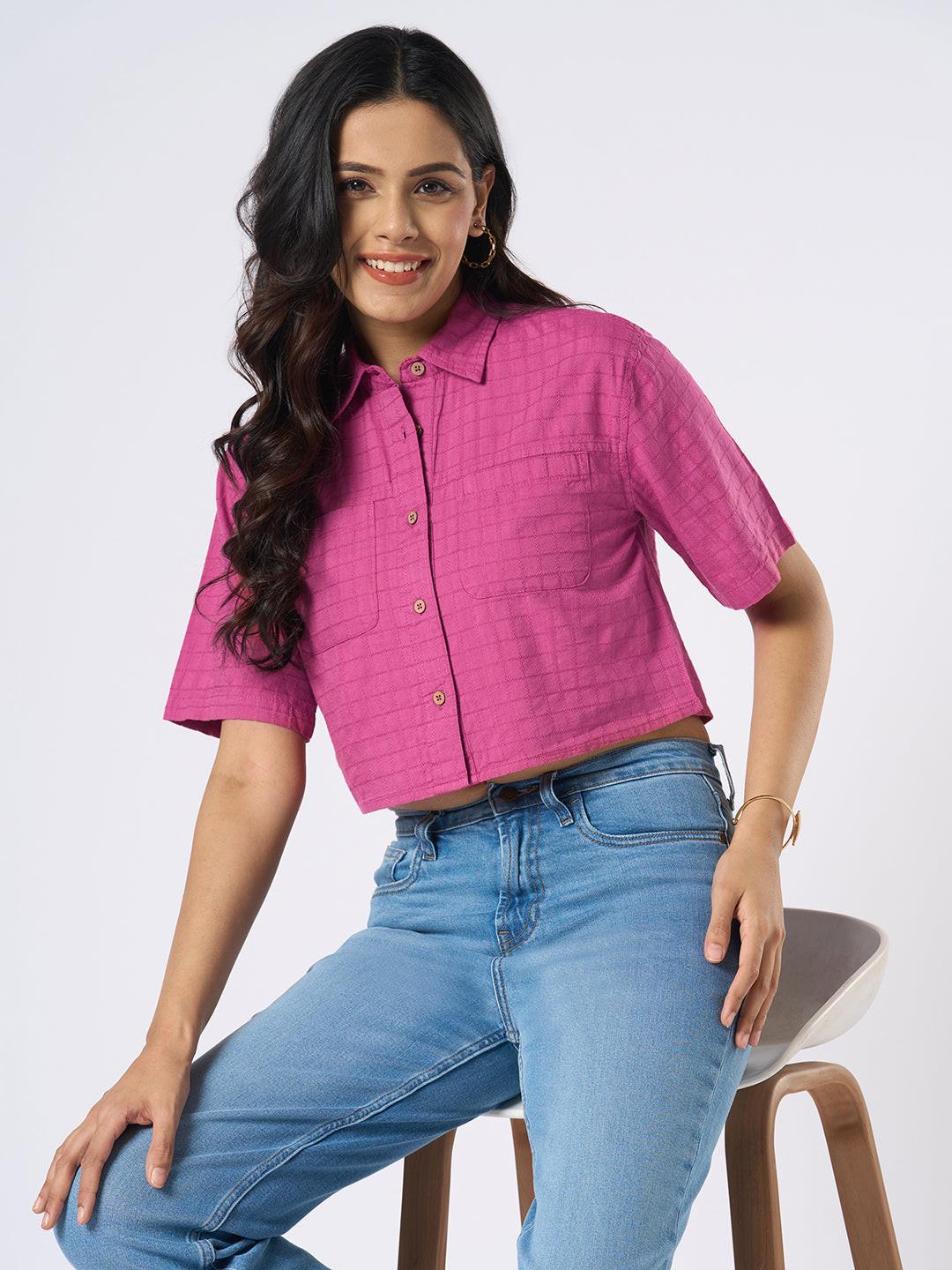 Woman wearing a pink checkered crop top by Rerasa