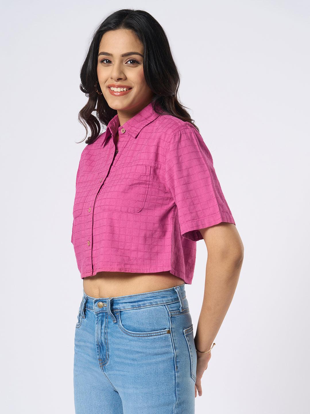 Woman wearing a pink checkered crop top by Rerasa