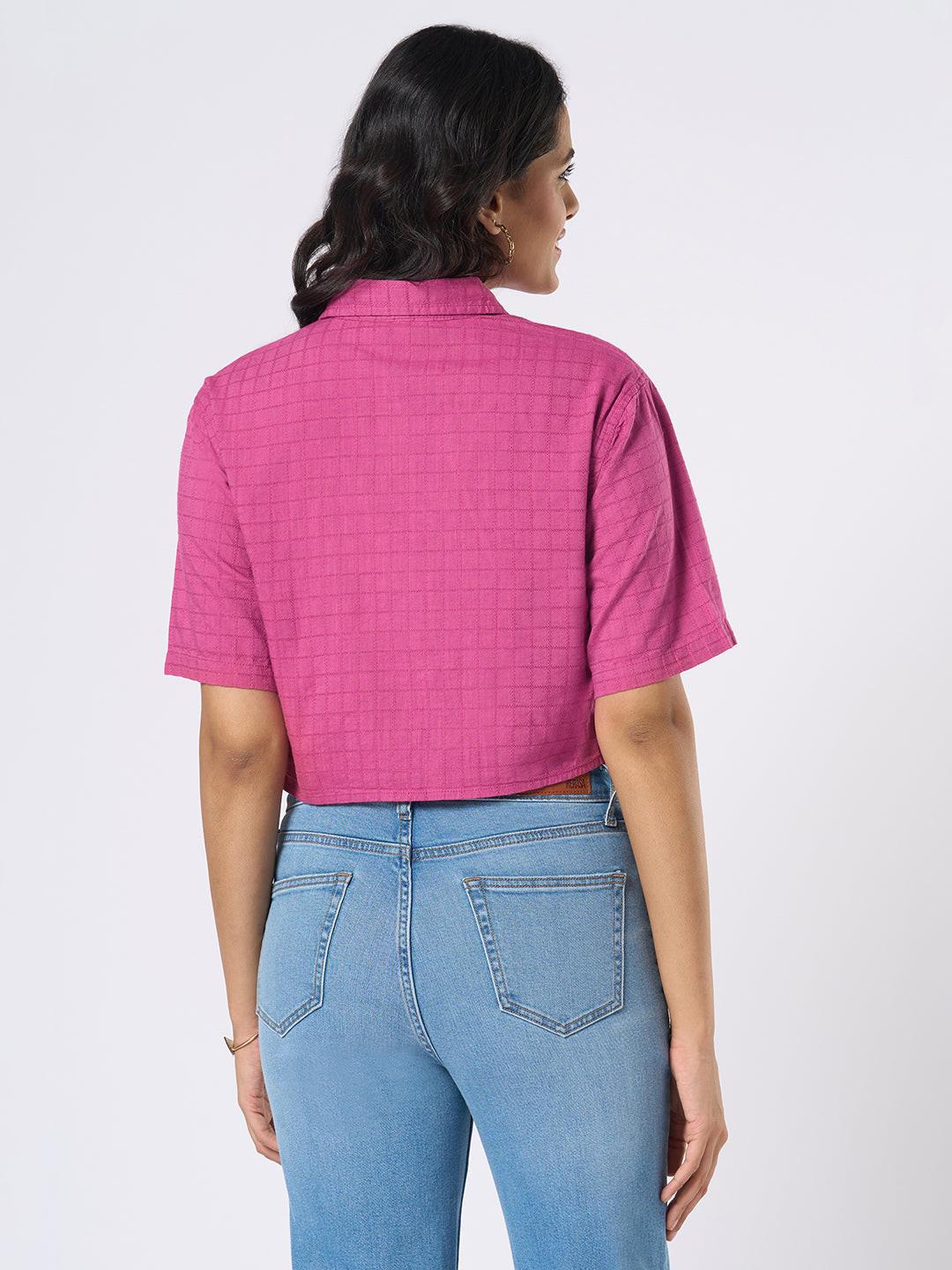 Woman wearing a pink checkered crop top by Rerasa