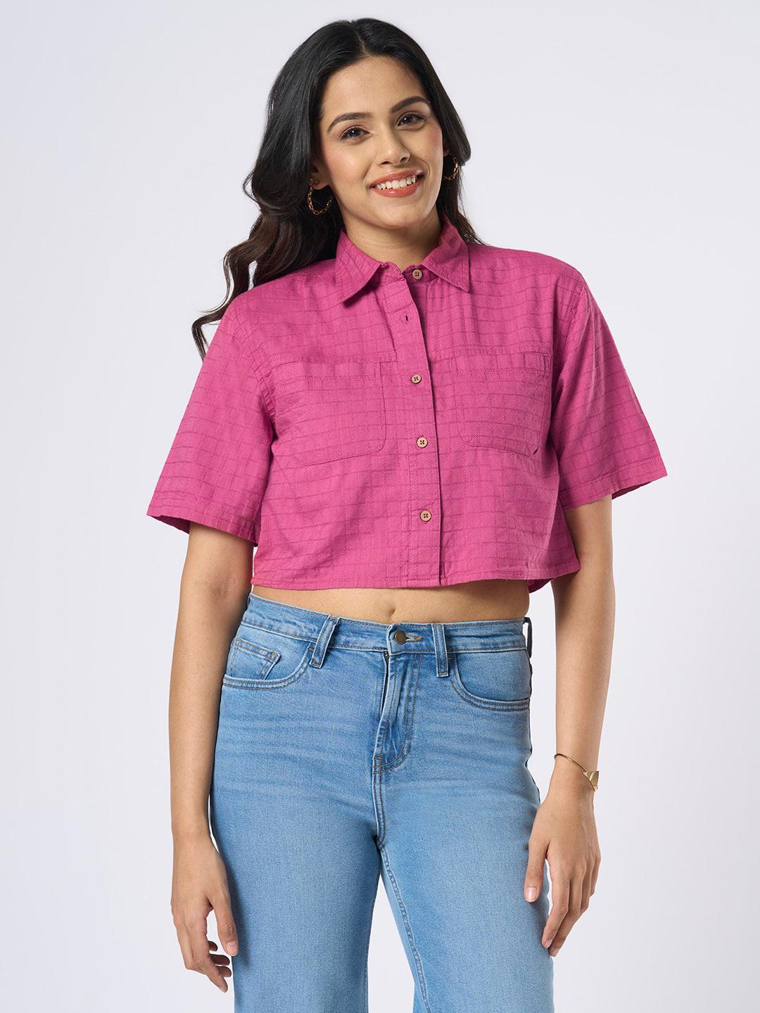 Woman wearing a pink checkered crop top by Rerasa