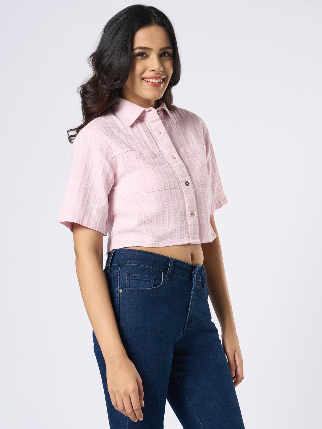 Woman wearing a pink checkered crop top by Rerasa