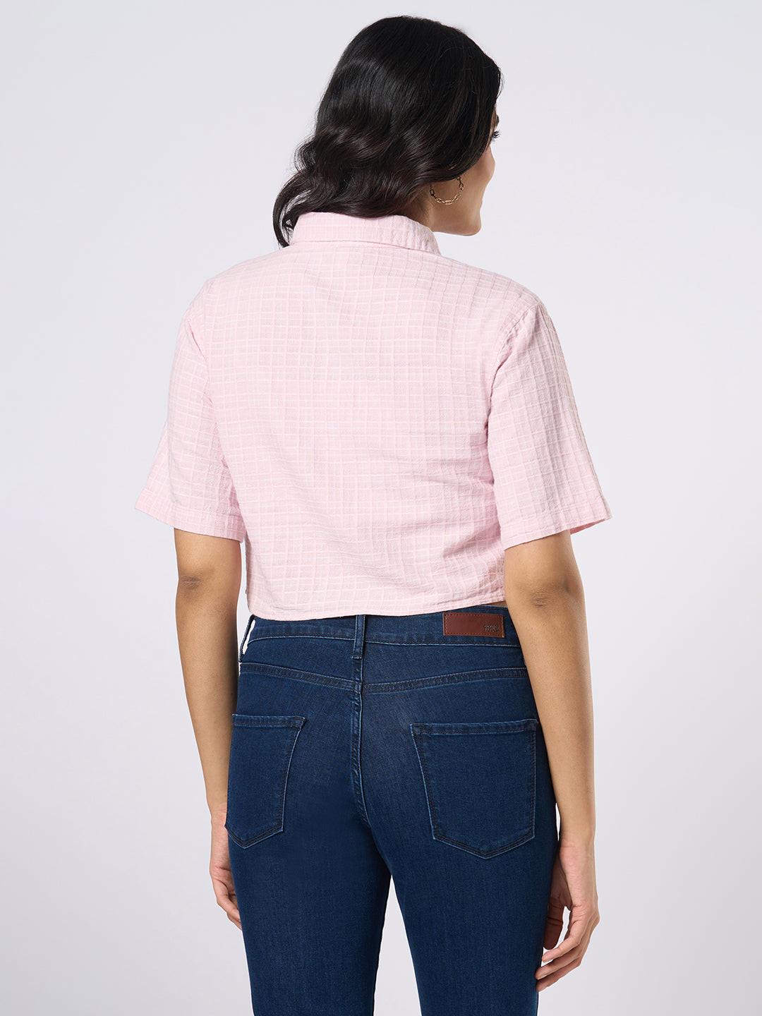 Woman wearing a pink checkered crop top by Rerasa