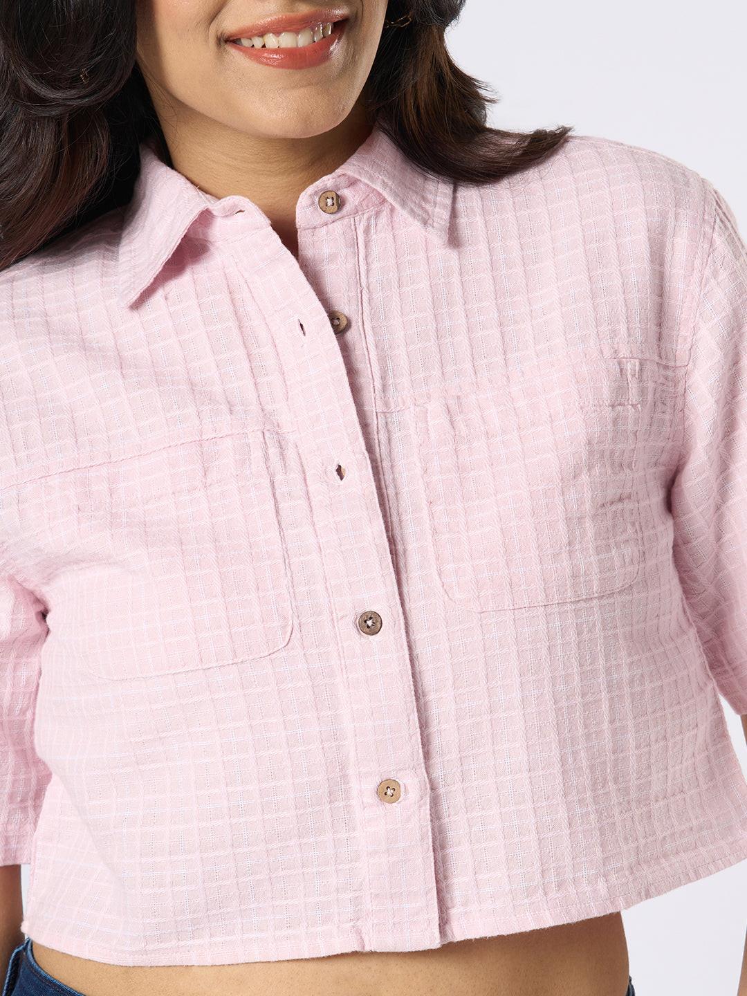 Woman wearing a pink checkered crop top by Rerasa