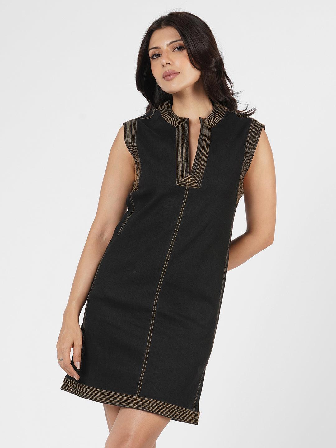 Woman wearing a black dress with brown trim
