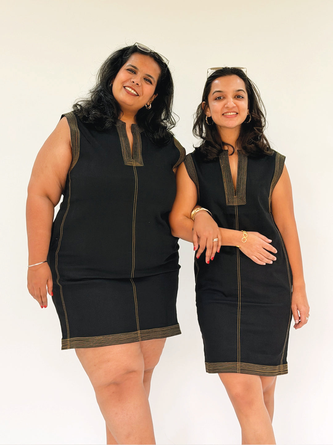 Women wearing a black dress with brown trim 