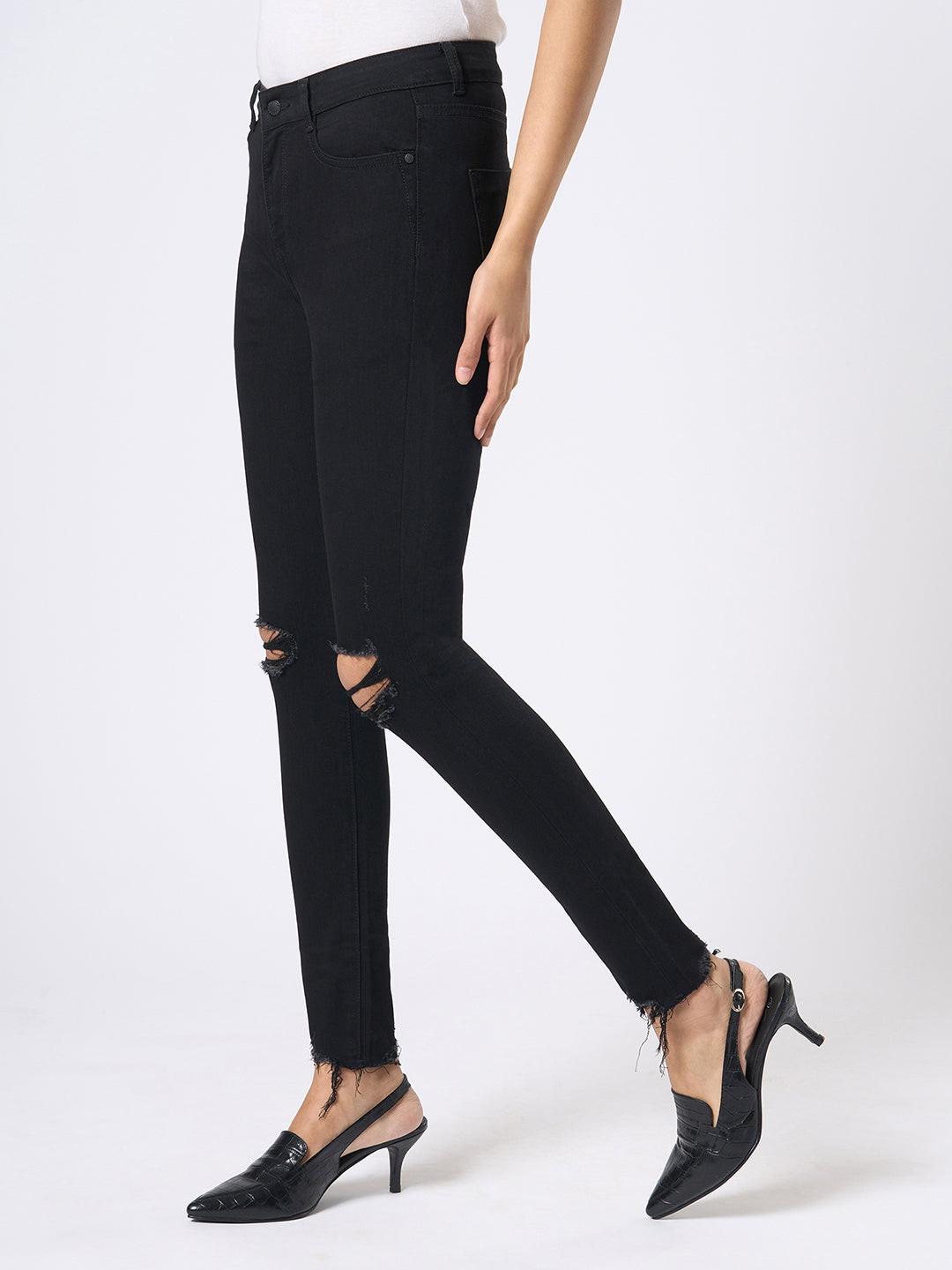 Rerasa Black distressed jeans worn by a person on a white background