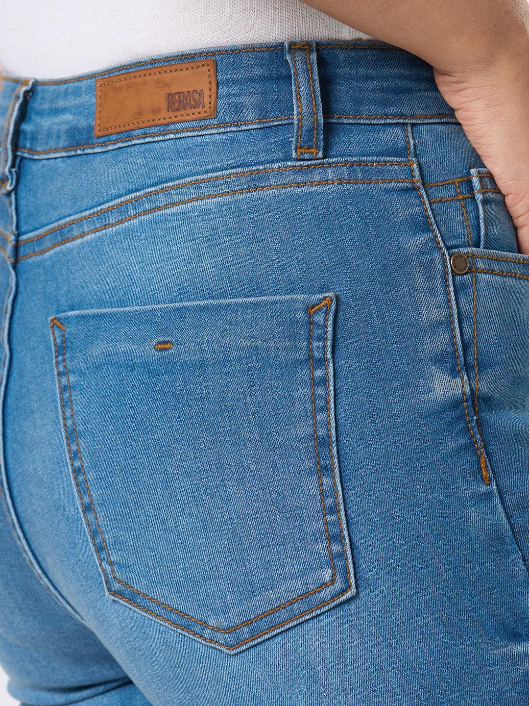 Close-up of Rerasa blue jeans with a brand label on the pocket.