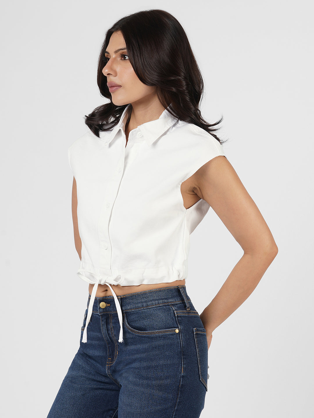 Woman wearing a white cap sleeves top by Rerasa