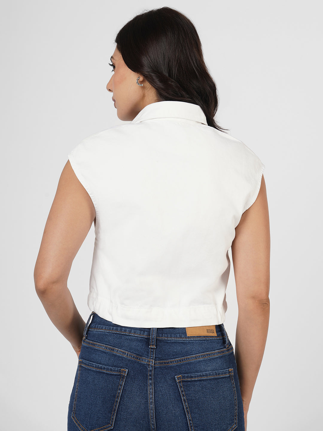 Woman wearing a white cap sleeves top by Rerasa