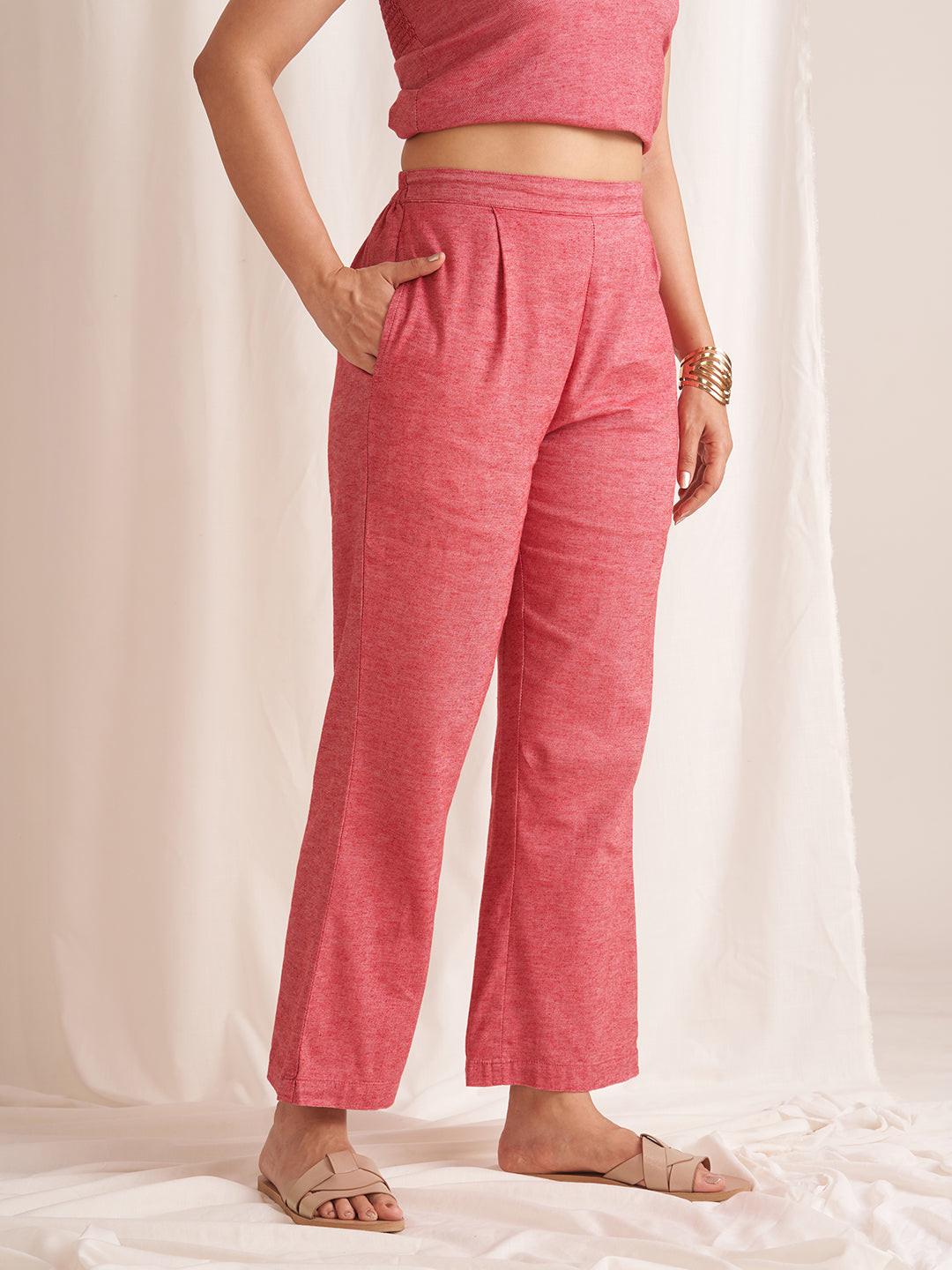 Person wearing RERASA pink pants and a matching top on a white background