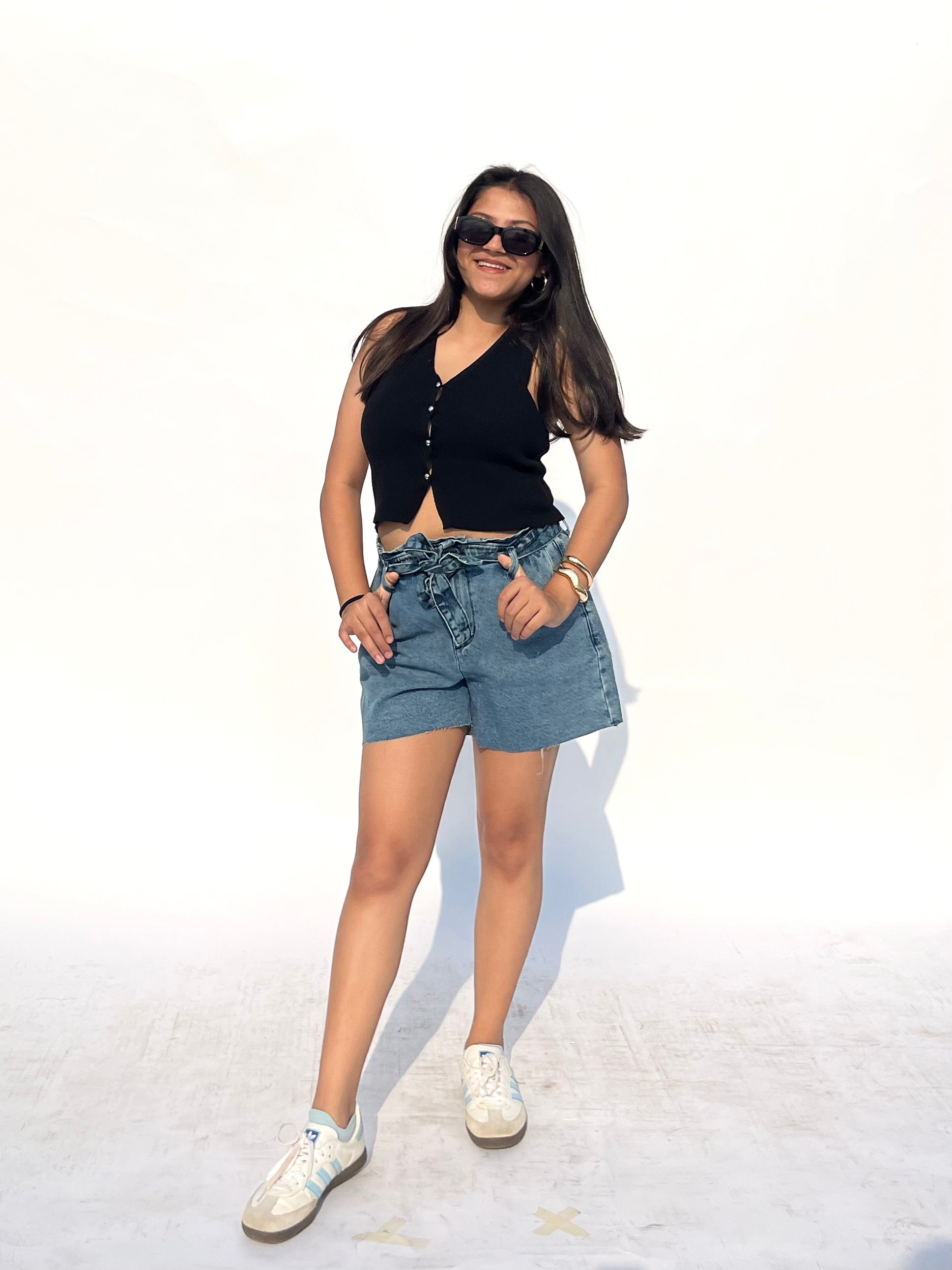 Person wearing blue denim shorts with a tie waist by Rerasa