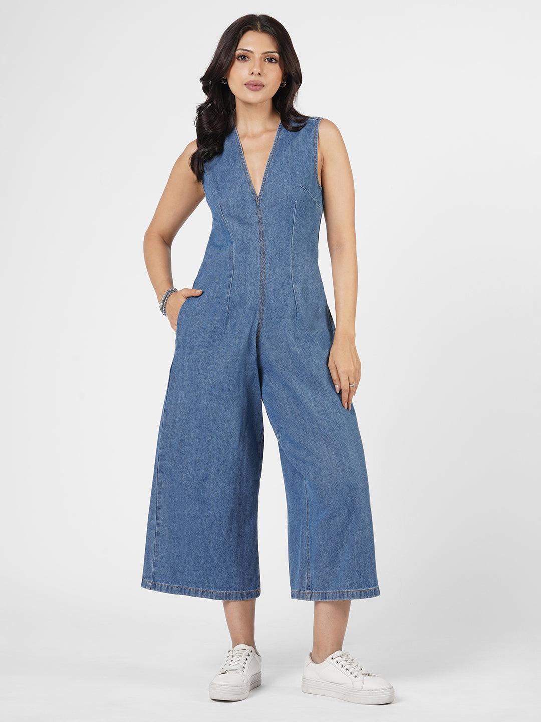 Woman wearing a blue denim jumpsuit  by Rerasa