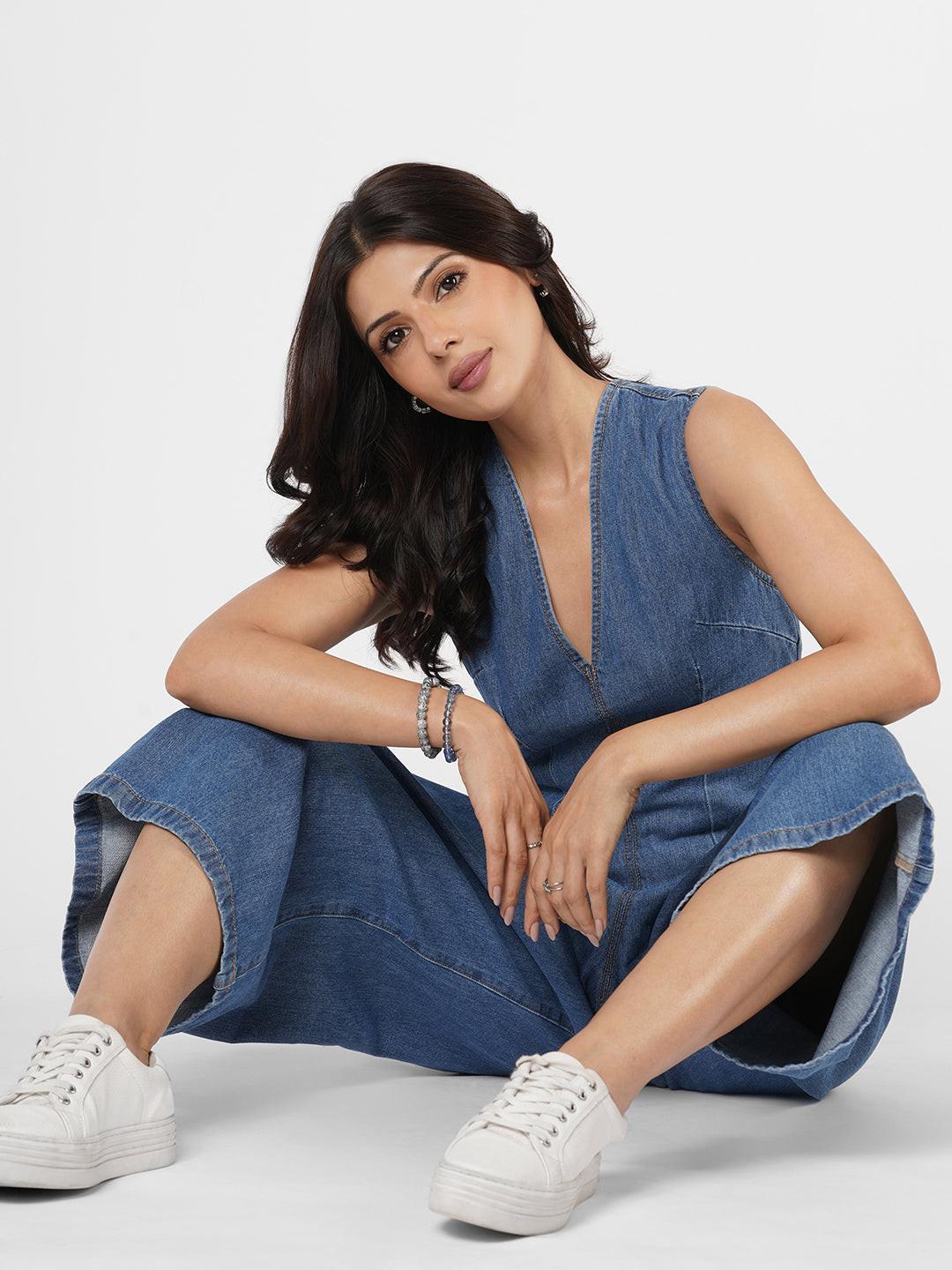 Woman wearing a blue denim jumpsuit  by Rerasa