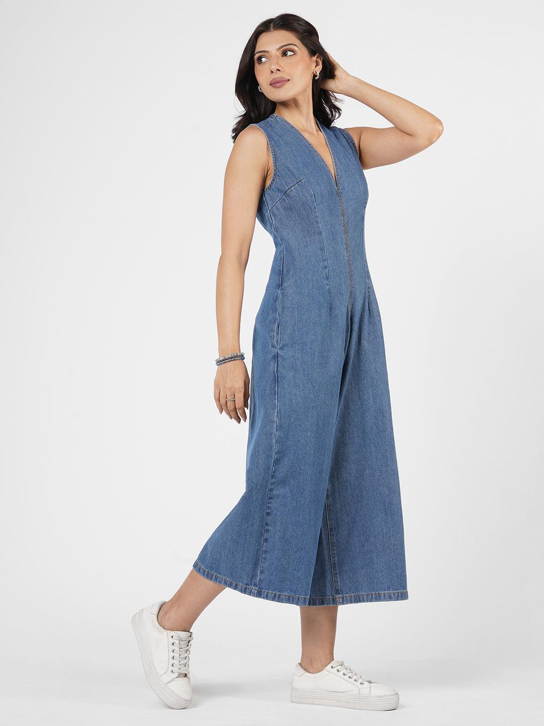 Woman wearing a blue denim jumpsuit  by Rerasa