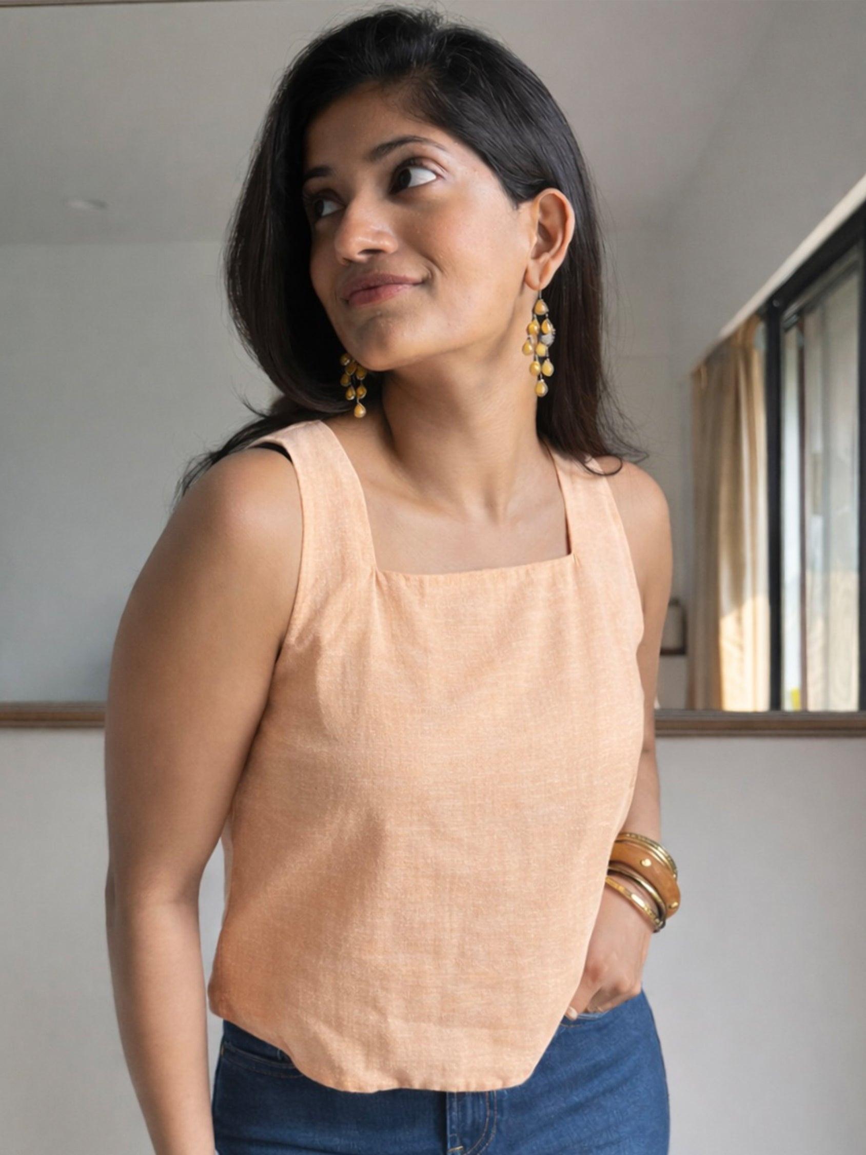 Woman wearing a Yellow sleeveless top 