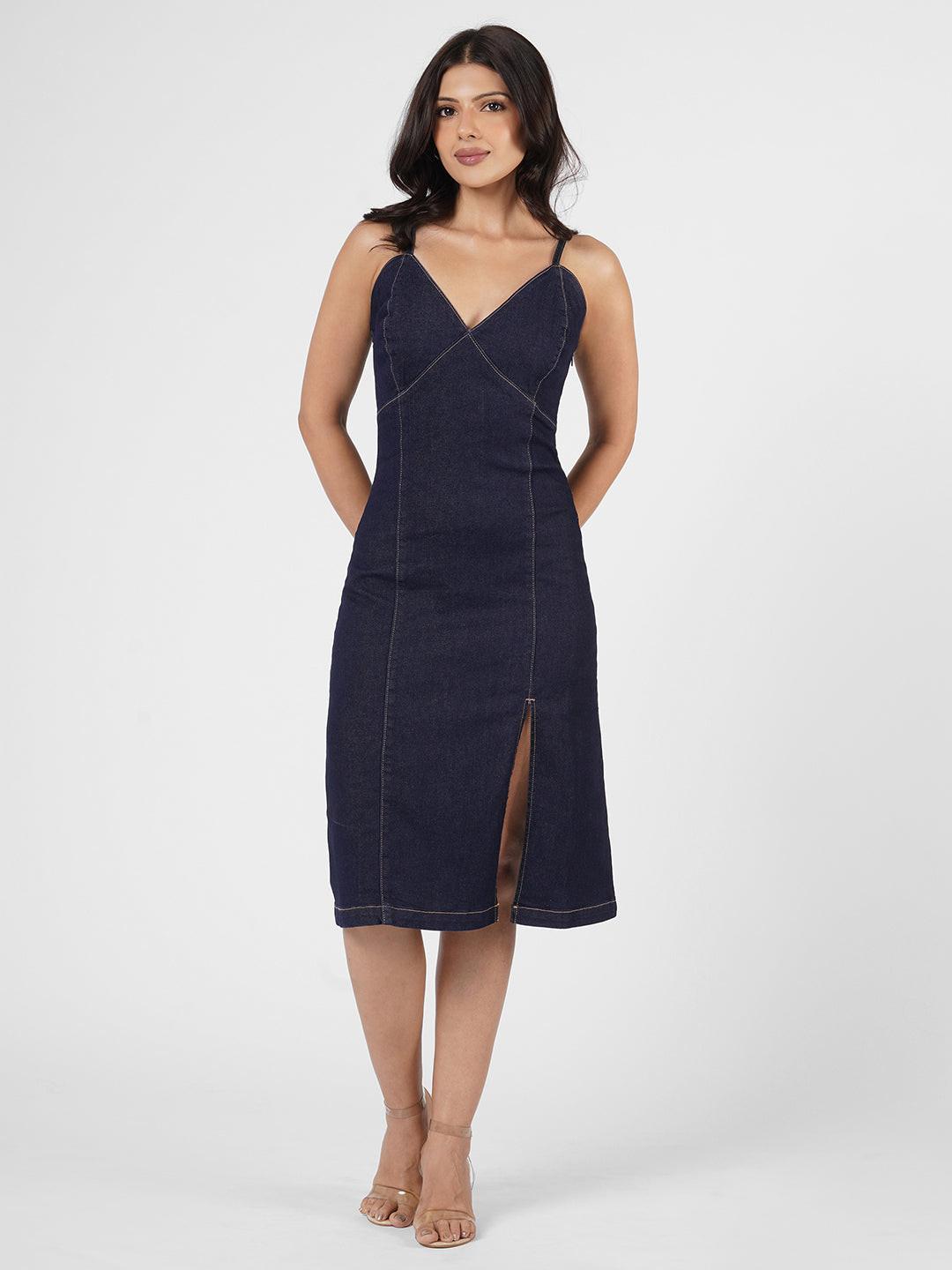 Woman wearing a navy blue spaghetti denim dress 