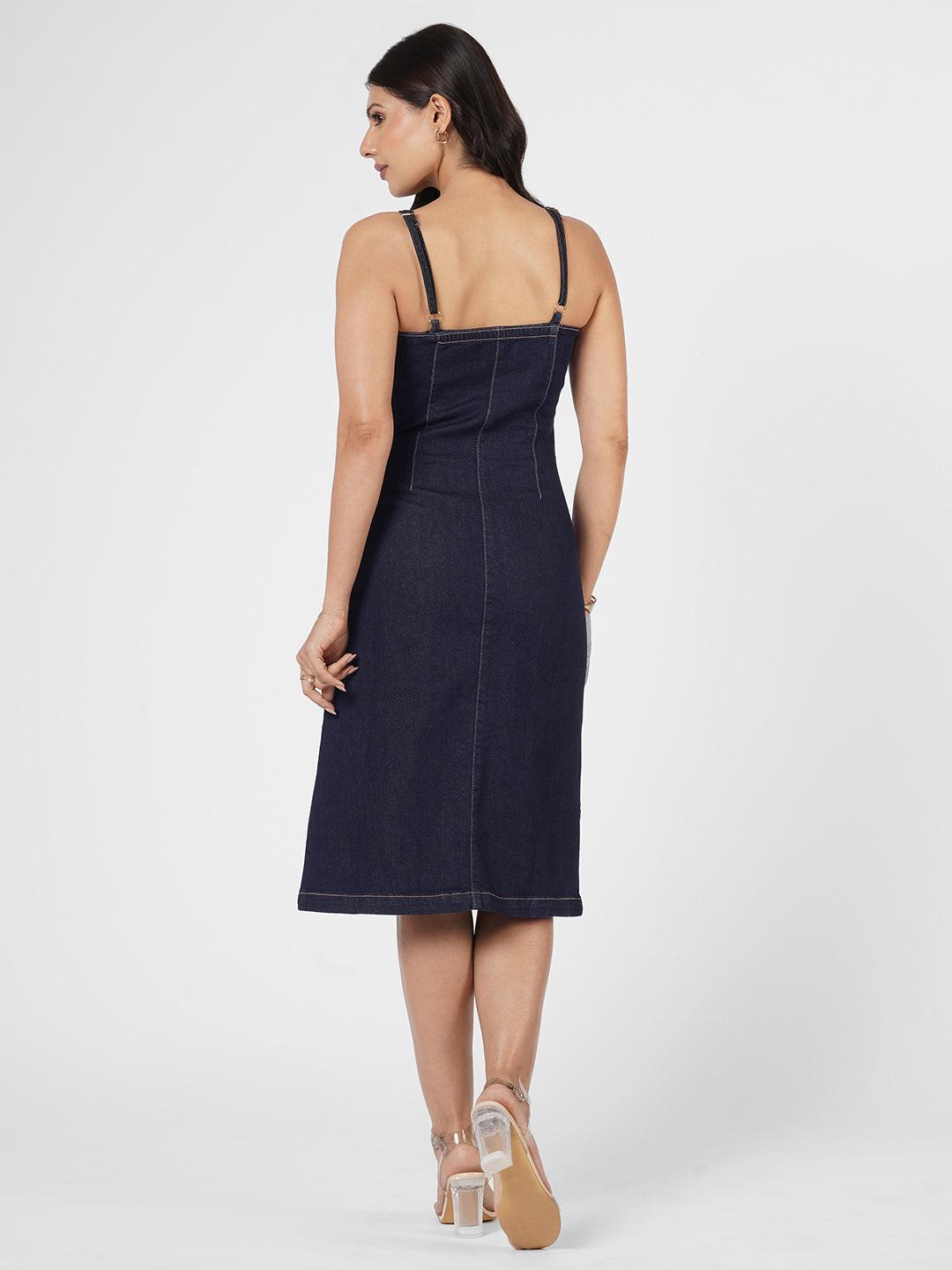 Woman wearing a navy blue spaghetti denim dress 