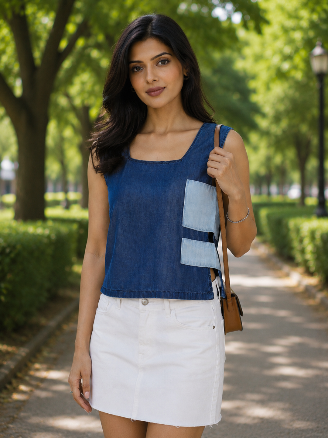 Woman wearing a blue sleeveless top by Rerasa
