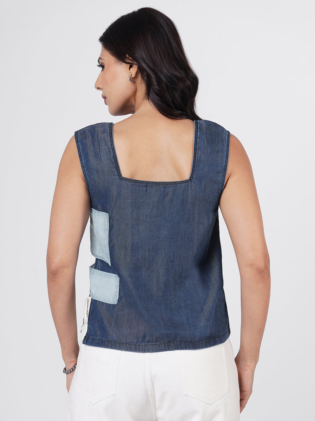 Woman wearing a blue sleeveless top by Rerasa