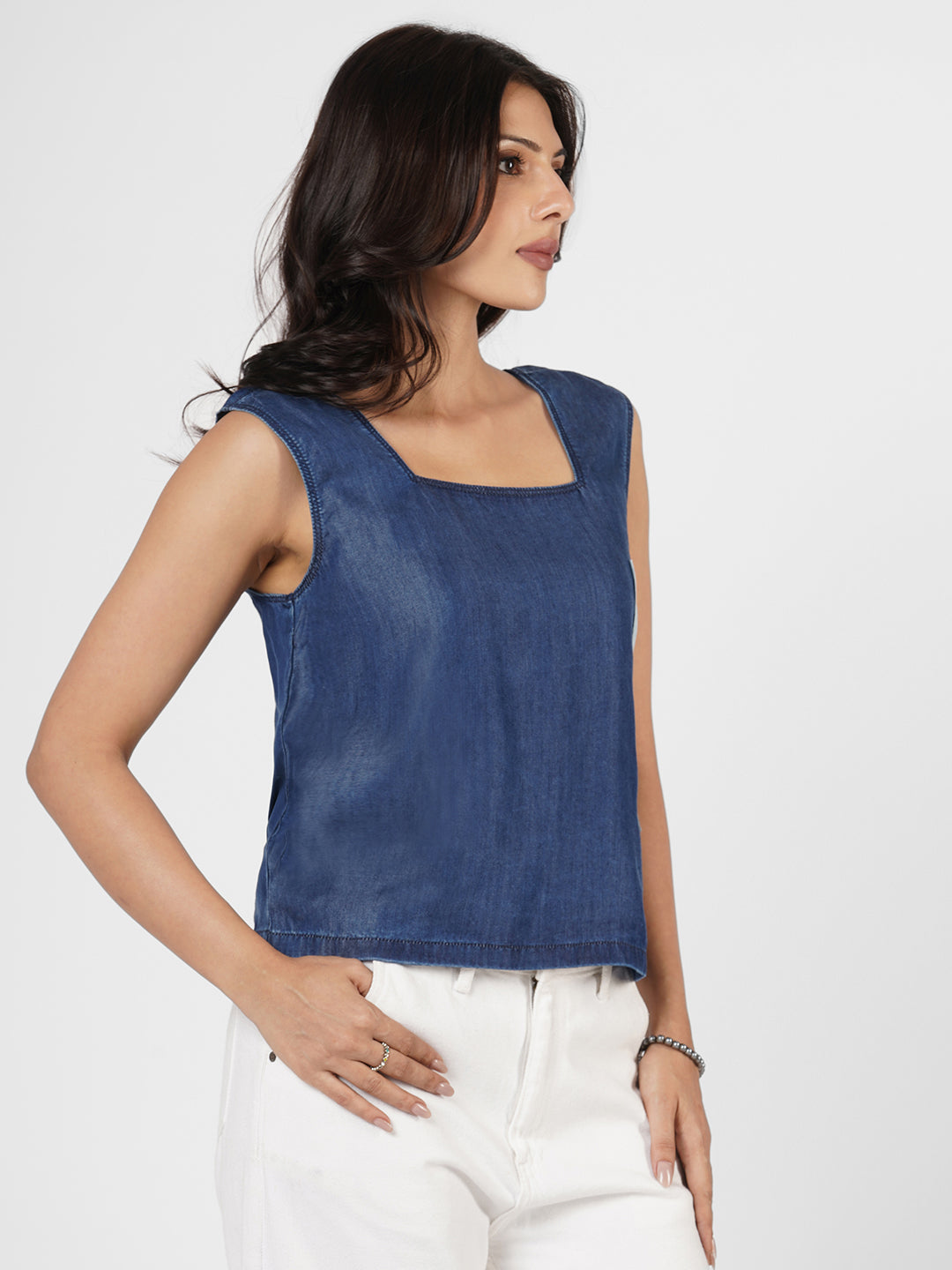 Woman wearing a blue sleeveless top by Rerasa