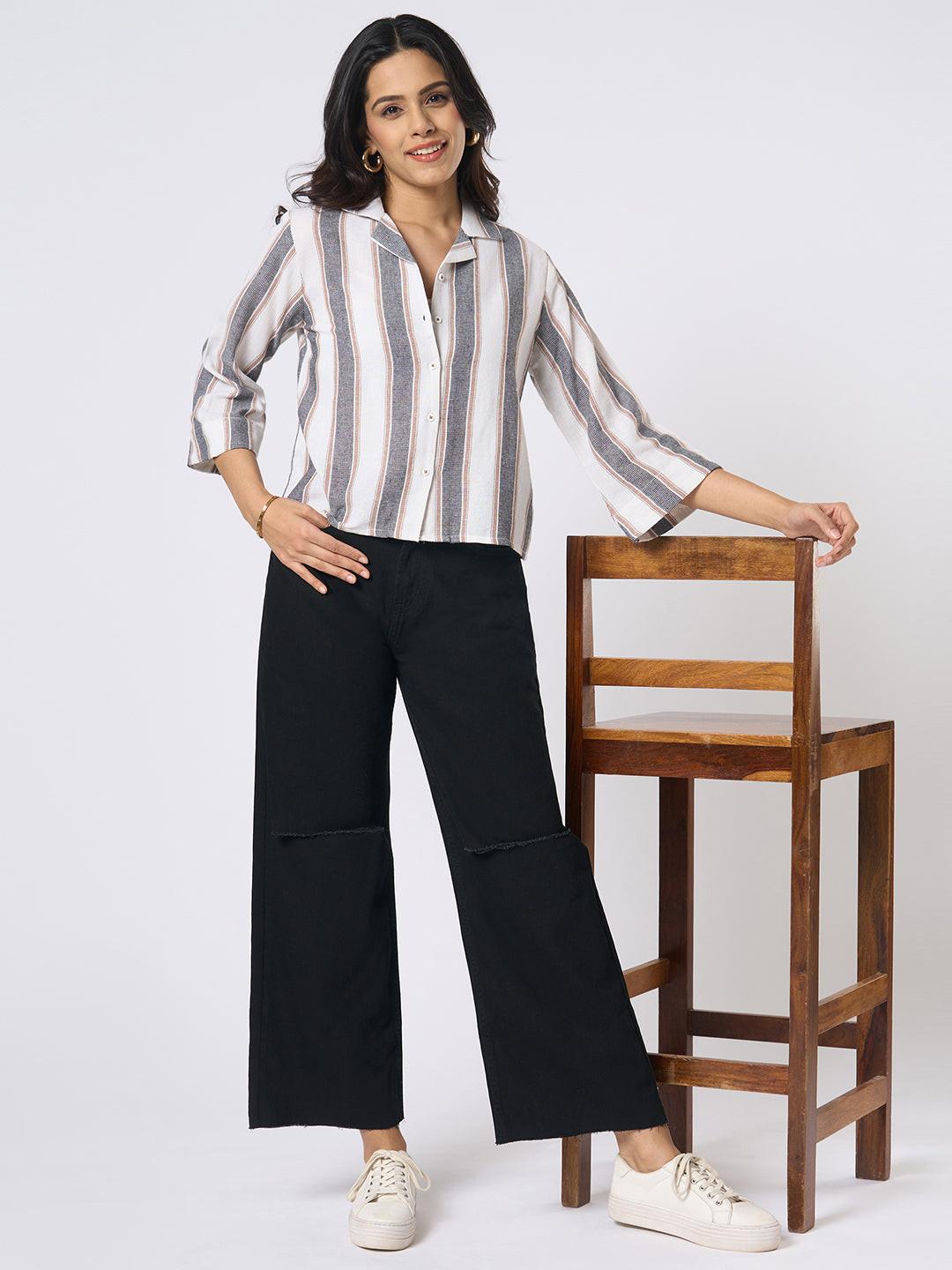 Person wearing black wide-leg jeans with distressed details by Rerasa