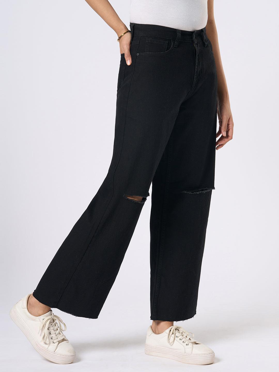 Person wearing black wide-leg jeans with distressed details by Rerasa