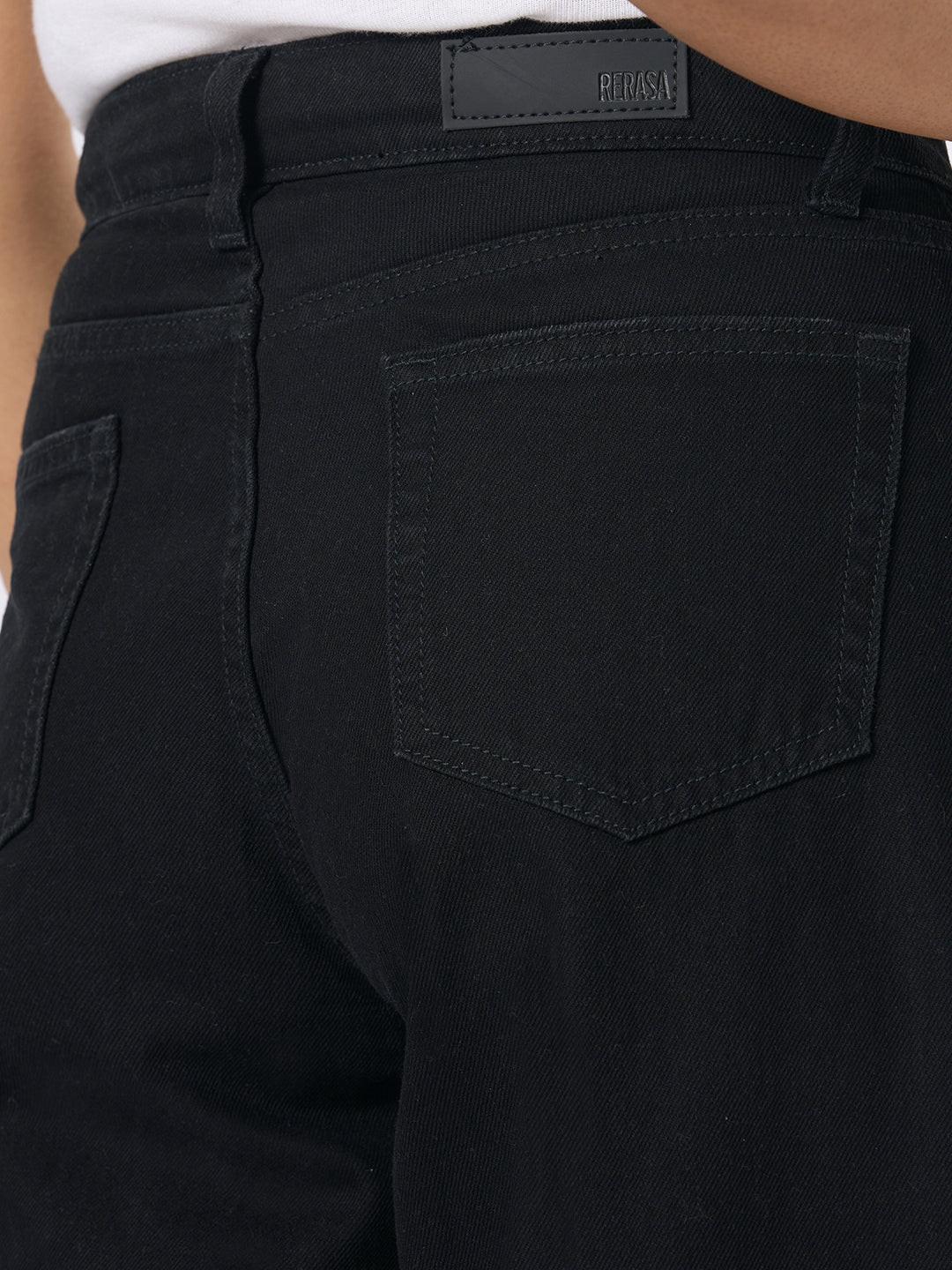 Person wearing black wide-leg jeans with distressed details by Rerasa