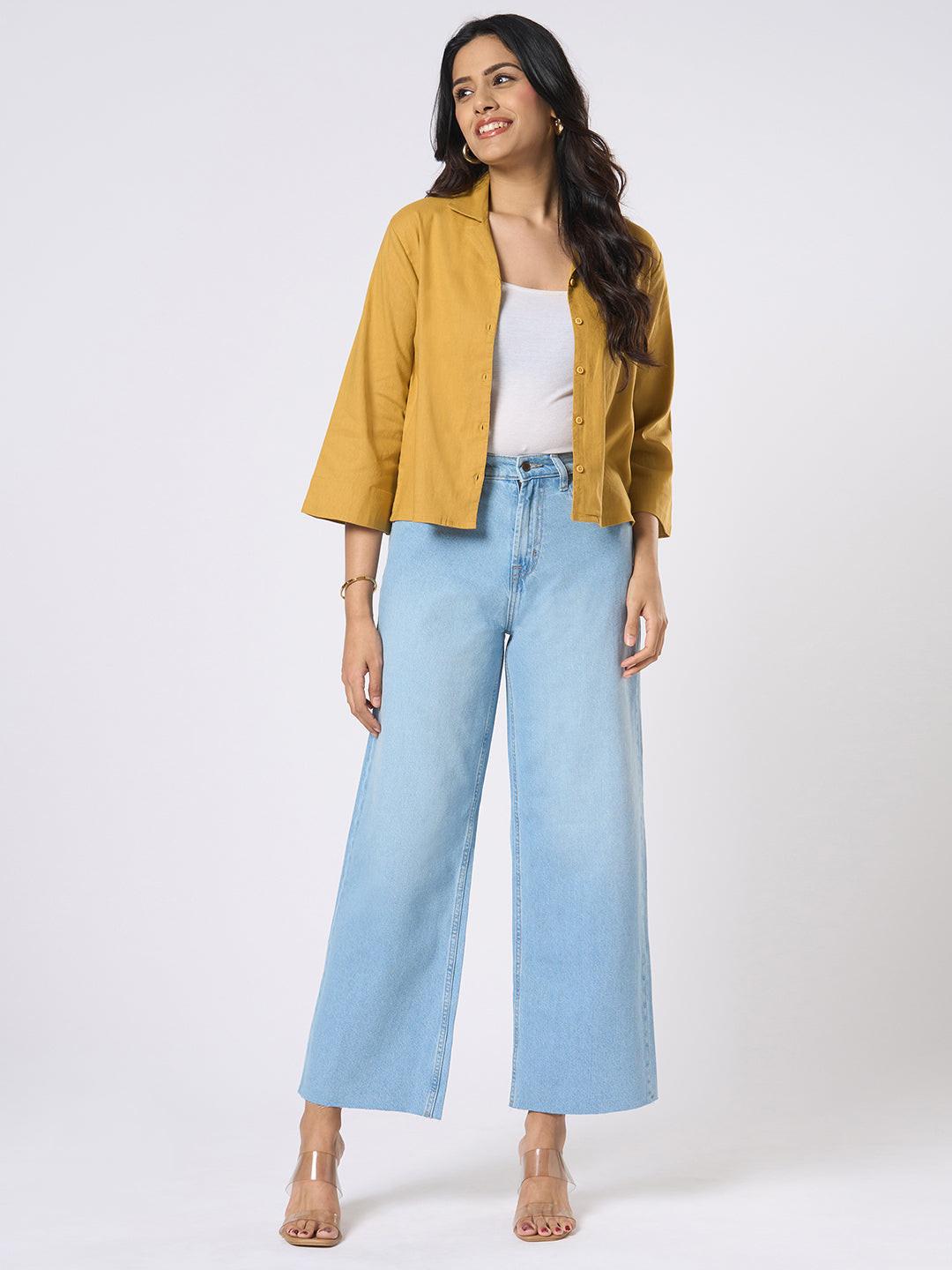 Person wearing blue wide-leg jeans with distressed details by Rerasa