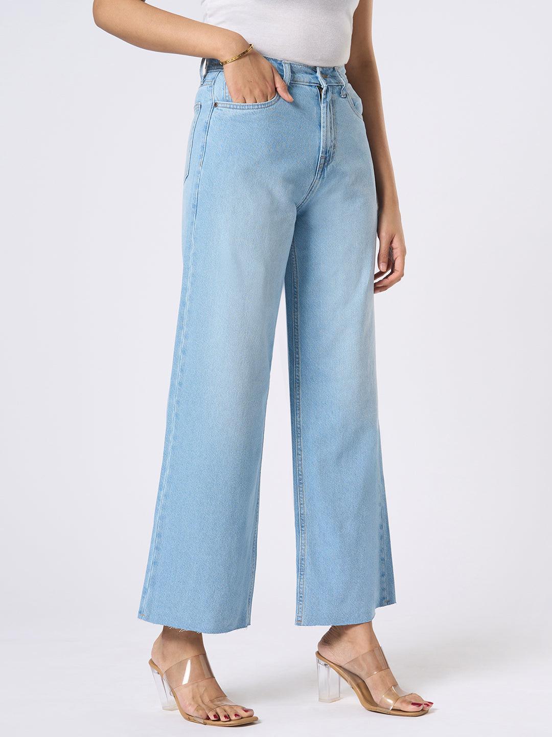 Person wearing blue wide-leg jeans with distressed details by Rerasa