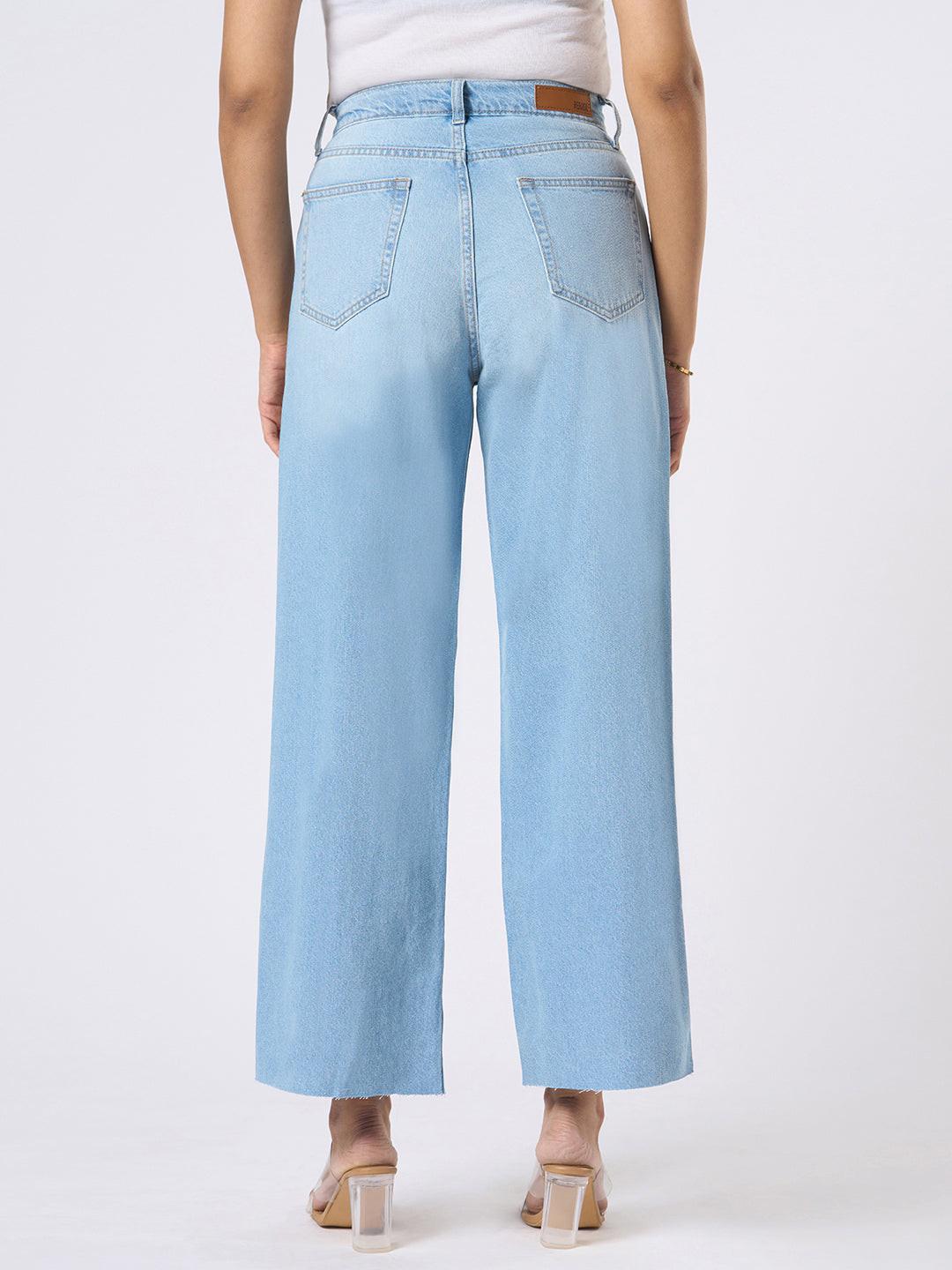 Person wearing blue wide-leg jeans with distressed details by Rerasa