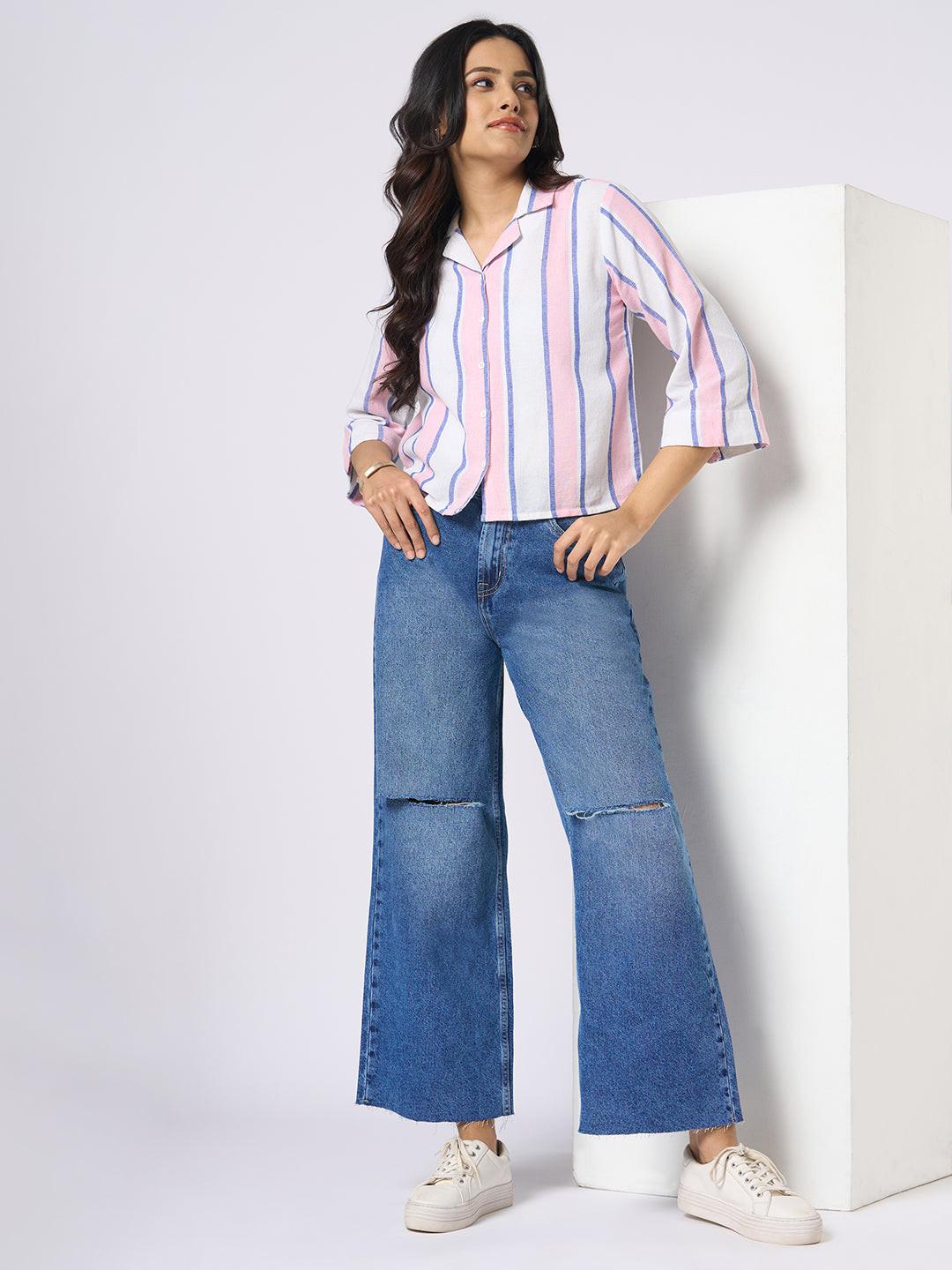 Person wearing blue wide-leg jeans with distressed details by Rerasa