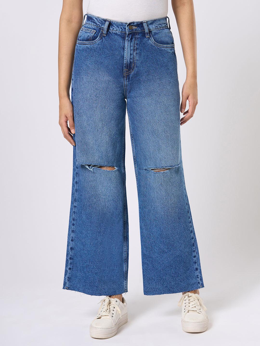 Person wearing blue wide-leg jeans with distressed details by Rerasa