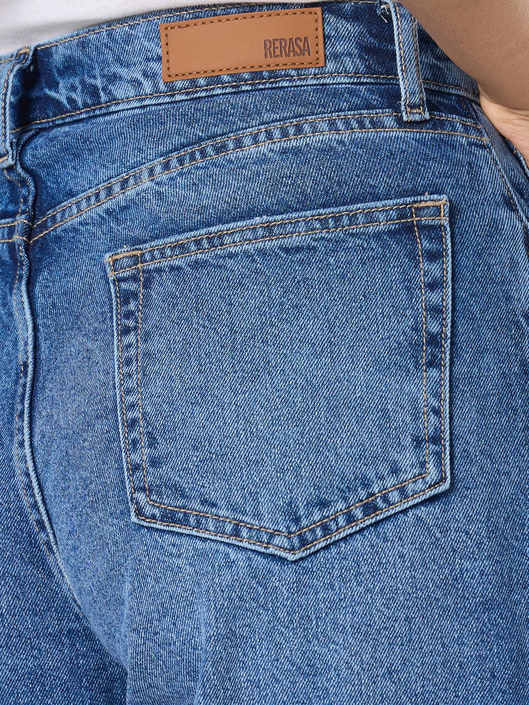 Person wearing blue wide-leg jeans with distressed details by Rerasa