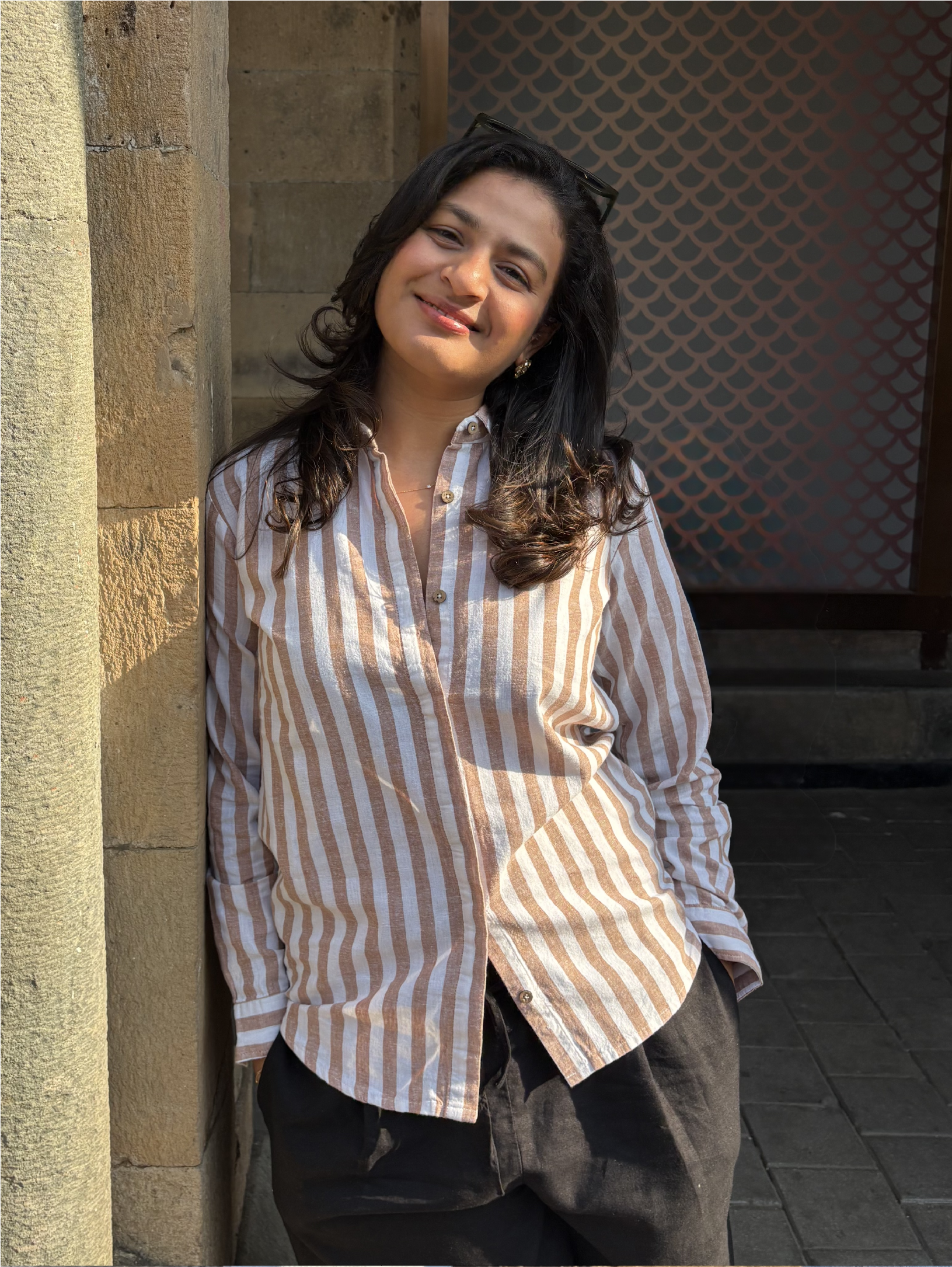 Woman wearing a Rerasa beige and white striped shirt